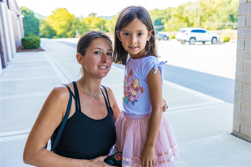 A mother and daughter smile